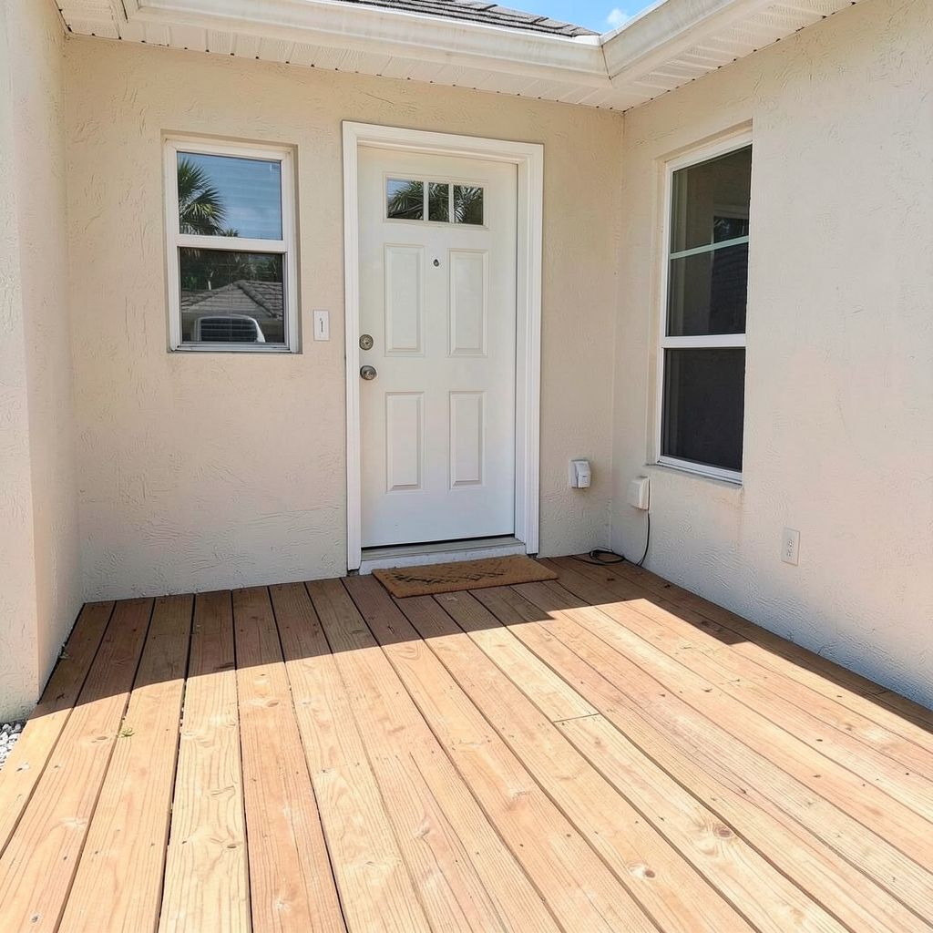 Residential deck cleaning service in Palm Beach Gardens Florida with clean natural wood grain visible on a newly cleaned wooden deck.